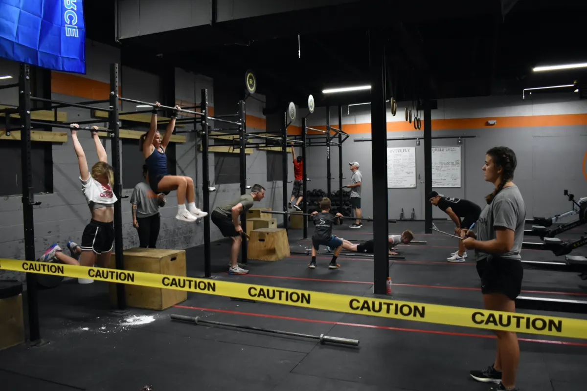 Wide competition floor with athletes working multiple stations
