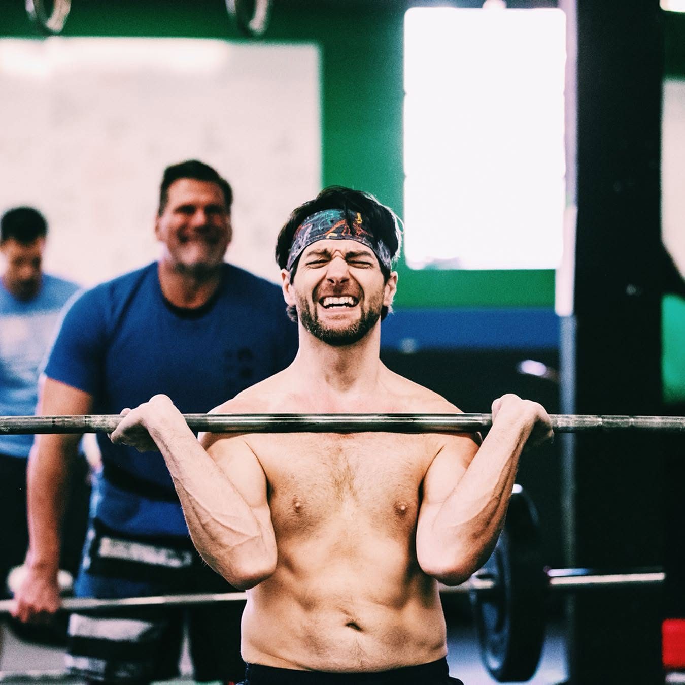 A masters athlete gritting through a front-rack hold